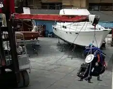 electric sailboat motor being lifted in boat