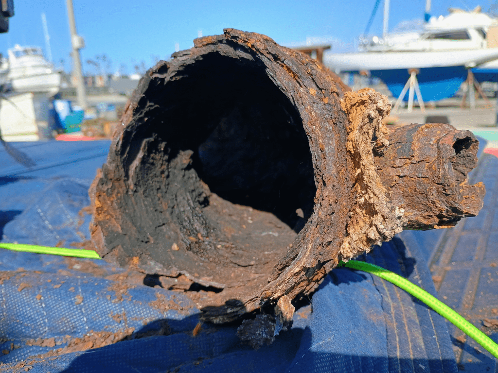 Completely corroded Detroit Diesel 8V53T wet exhaust mixing elbow, perforated and crumbling from severe rust in Channel Islands Harbor