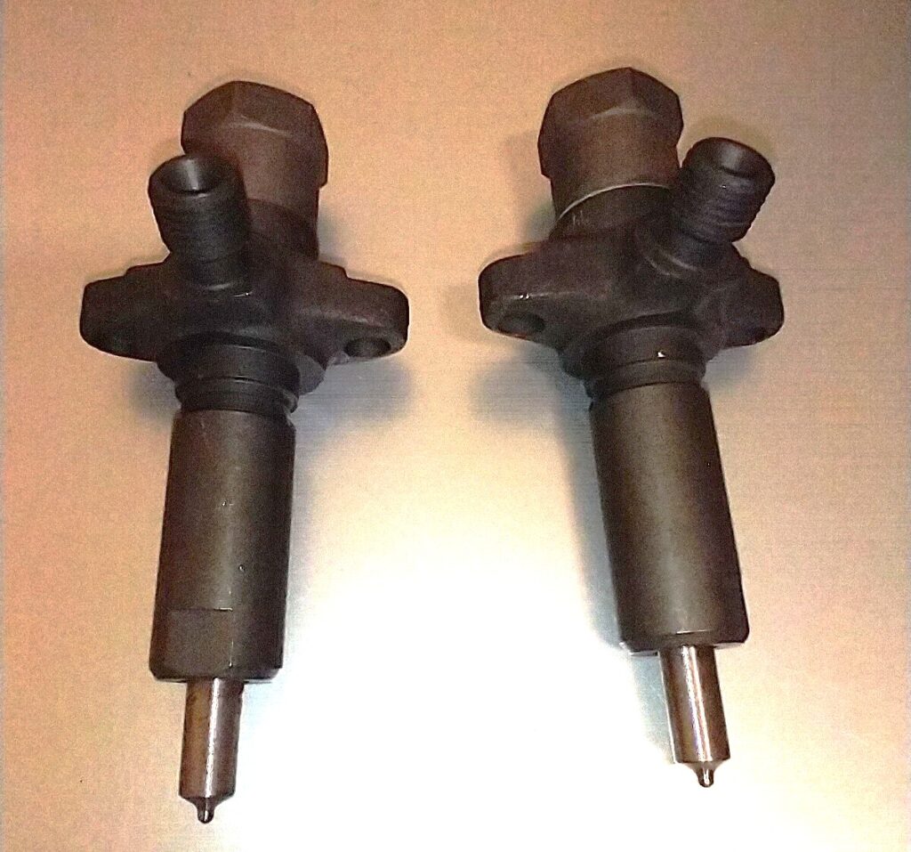 Ford Lehman marine diesel fuel injectors shown side by side