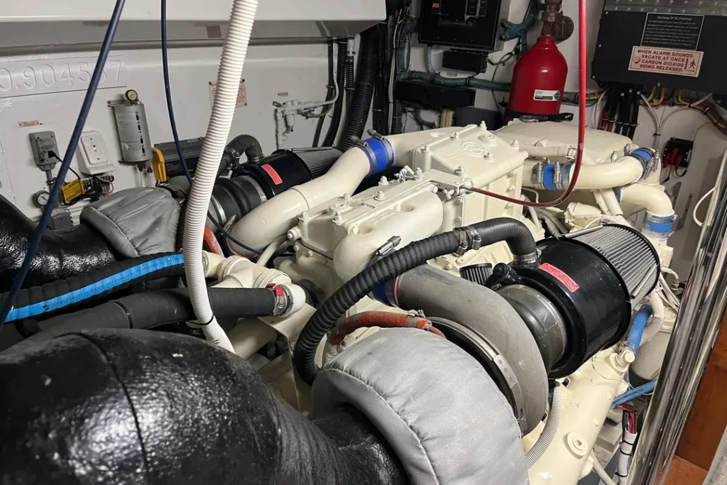 Clean Detroit Diesel 12V71TI engine room aboard Hatteras Lady T during marine engine survey