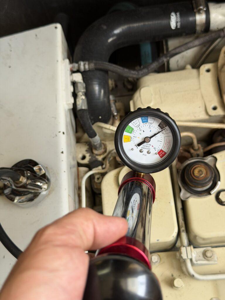 Cummins 6BTA5.9 M3 marine diesel engine cooling-system pressure leak-down test performed during Luhrs 34 marine engine survey