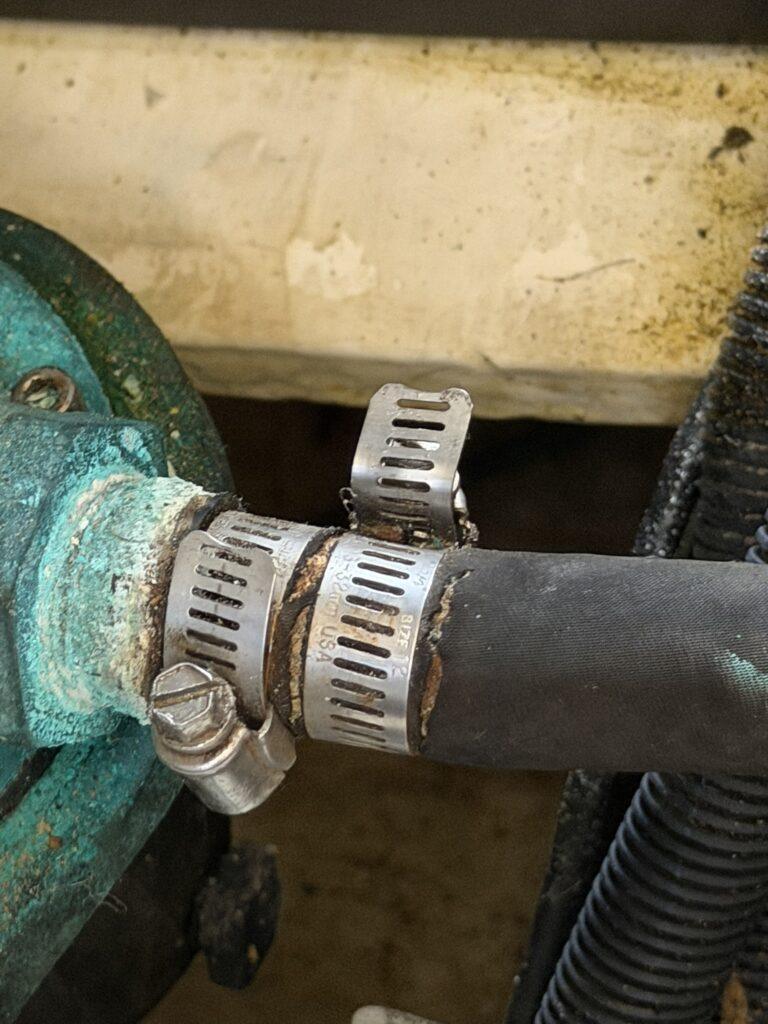 Damaged Cummins 6BTA5.9 M3 transmission oil cooler hoses requiring replacement during Luhrs 34 marine engine survey