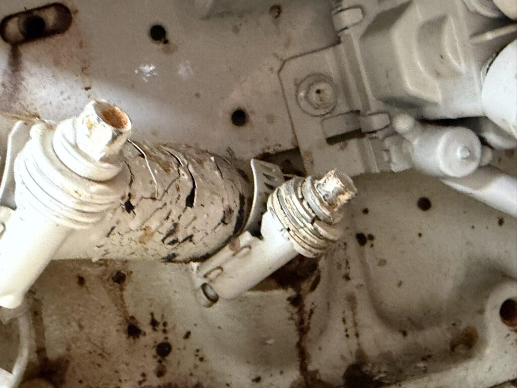 Damaged port Cummins 6BTA5.9 M3 cooling-system hoses and hose clamps requiring replacement during marine engine survey
