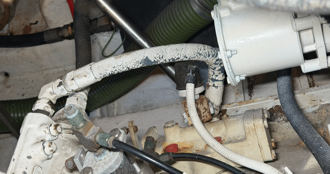 Crimped marine diesel fuel oil and Twin Disc transmission lines identified for replacement on twin MAN D2848LE401 engines